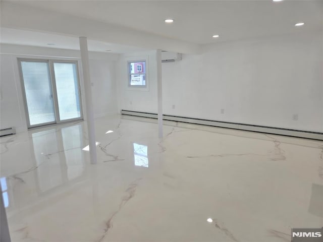 basement featuring an AC wall unit and a baseboard heating unit