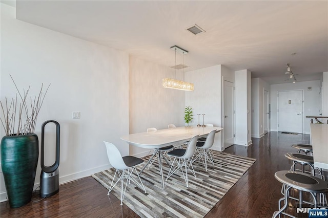 dining space with dark wood-type flooring