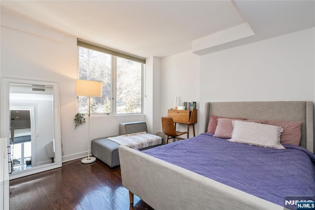 bedroom with dark hardwood / wood-style flooring