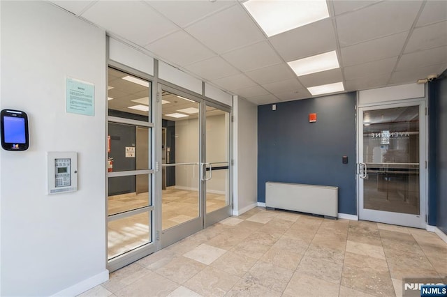 unfurnished room featuring a drop ceiling