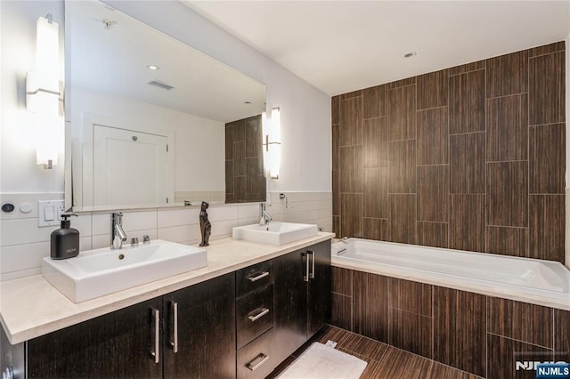 bathroom featuring tile walls and vanity