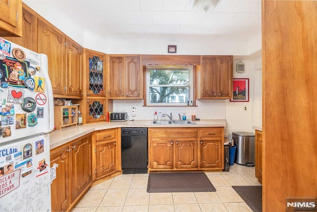 kitchen with sink, tasteful backsplash, light tile patterned floors, white refrigerator, and dishwasher