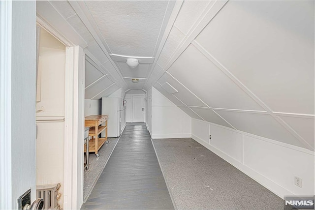 additional living space featuring vaulted ceiling