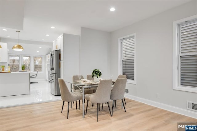 dining room with light hardwood / wood-style flooring