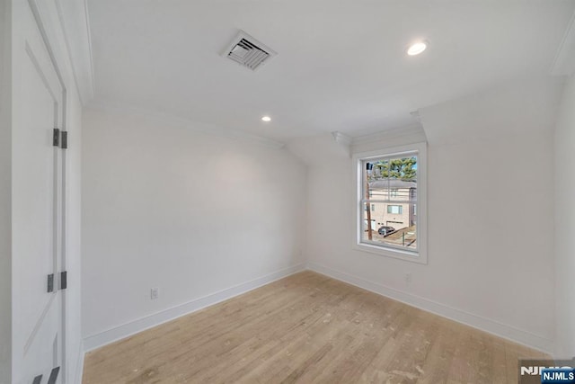 unfurnished room with crown molding and light wood-type flooring