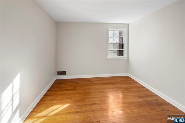 spare room featuring hardwood / wood-style floors