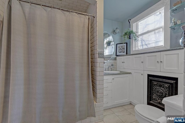 full bathroom with a shower with shower curtain, toilet, tile walls, and vanity