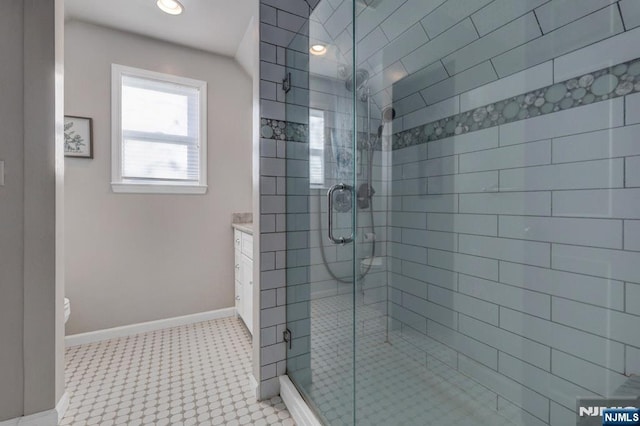 bathroom with recessed lighting, a shower stall, toilet, and baseboards