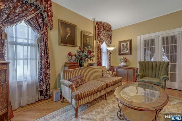 living area with wood finished floors and french doors