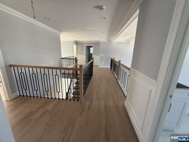 hall featuring ornamental molding and hardwood / wood-style floors