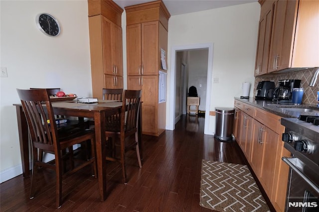 dining area featuring dark hardwood / wood-style flooring and sink