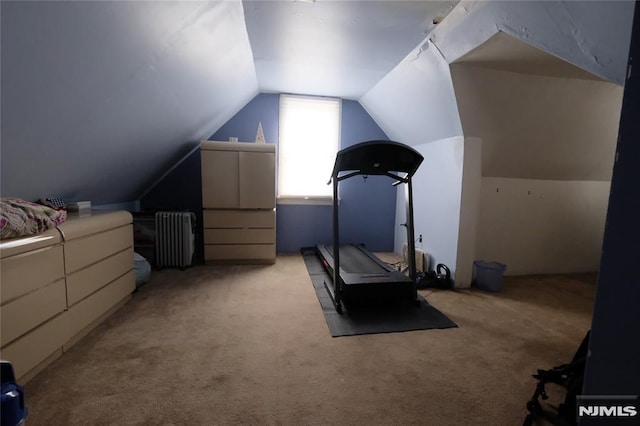 workout area with light carpet, radiator, and lofted ceiling