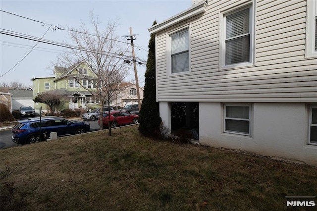 view of side of home featuring a yard