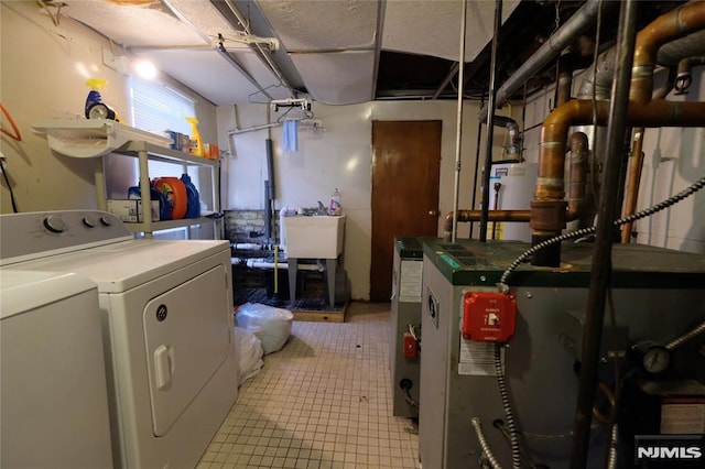 laundry area featuring sink, washer and dryer, and gas water heater