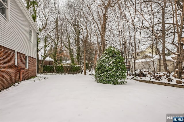 view of yard layered in snow