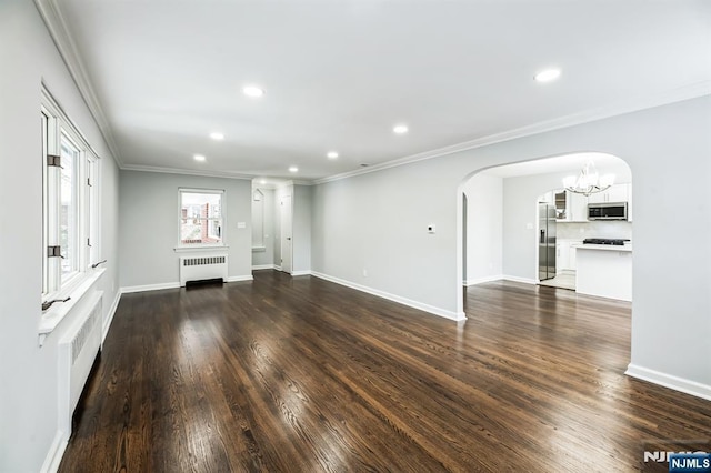 unfurnished living room with ornamental molding, dark hardwood / wood-style floors, radiator, and a notable chandelier