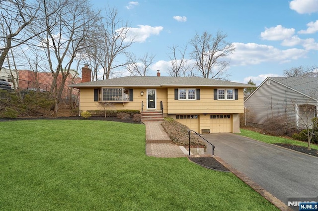 view of front of home with aphalt driveway, a front yard, a chimney, and an attached garage