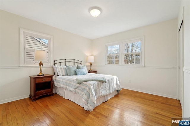 bedroom with light wood-type flooring and baseboards