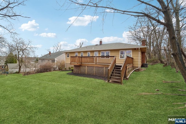 view of yard featuring a wooden deck and stairs