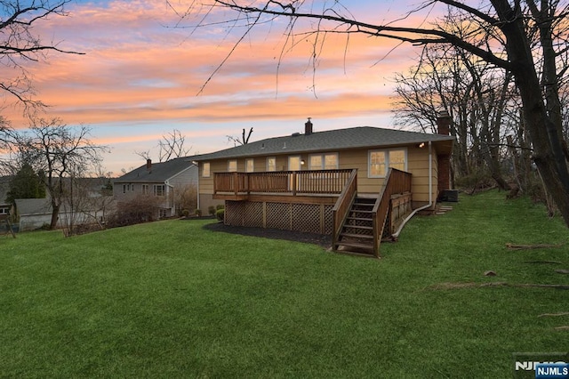 view of yard featuring a wooden deck and stairs