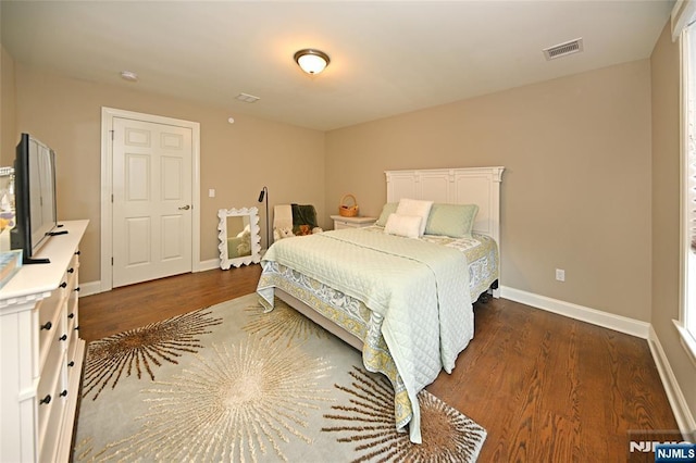 bedroom with dark hardwood / wood-style flooring