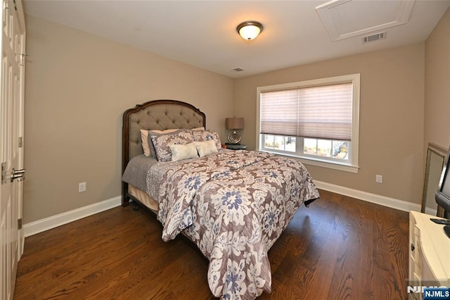 bedroom with dark hardwood / wood-style floors