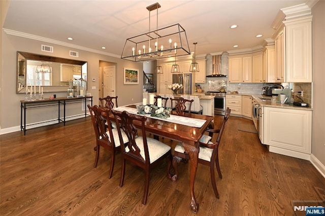 dining area featuring crown molding, dark hardwood / wood-style flooring, and a chandelier