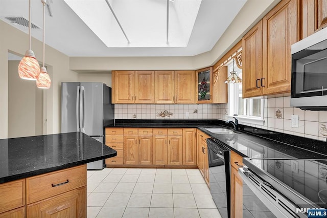 kitchen with decorative light fixtures, backsplash, dark stone counters, light tile patterned floors, and stainless steel appliances