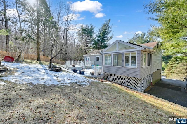 view of snow covered exterior featuring a deck