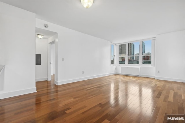 empty room with hardwood / wood-style floors