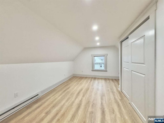 bonus room with lofted ceiling, light hardwood / wood-style floors, and baseboard heating