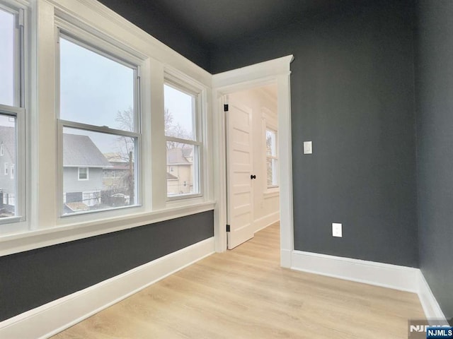 spare room featuring light hardwood / wood-style flooring