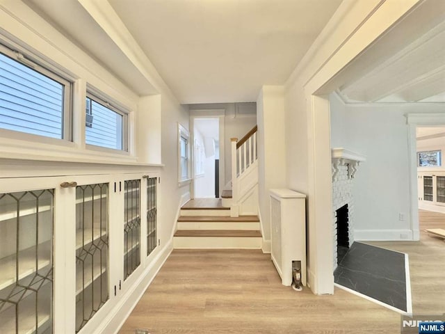 corridor with light hardwood / wood-style floors