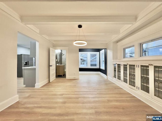 hall with beam ceiling and light hardwood / wood-style flooring