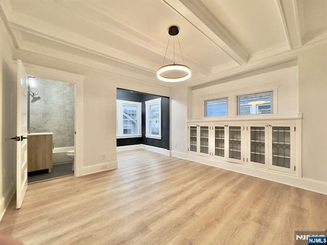 interior space featuring beam ceiling and light hardwood / wood-style floors