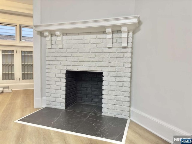 room details with hardwood / wood-style flooring and a fireplace