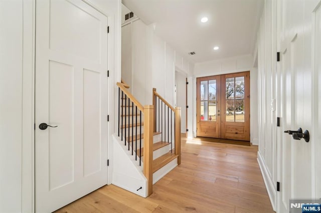 entryway with light wood-type flooring and french doors