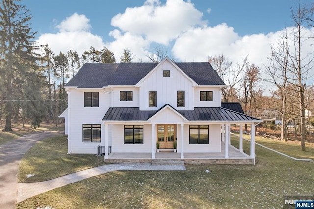 modern farmhouse style home featuring a front lawn and covered porch