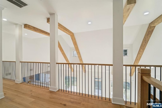 hallway featuring lofted ceiling with beams and hardwood / wood-style floors