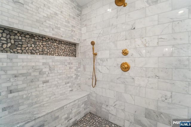 bathroom with tiled shower