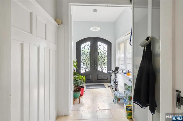 tiled entryway featuring french doors