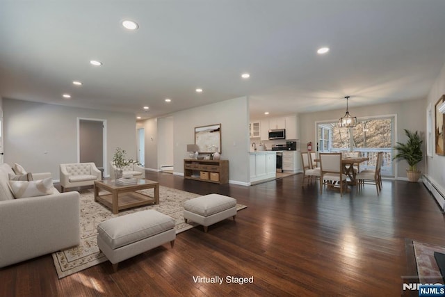 living room featuring a notable chandelier and dark hardwood / wood-style flooring