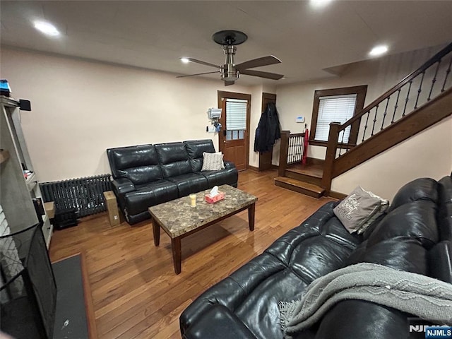 living room featuring hardwood / wood-style flooring and ceiling fan