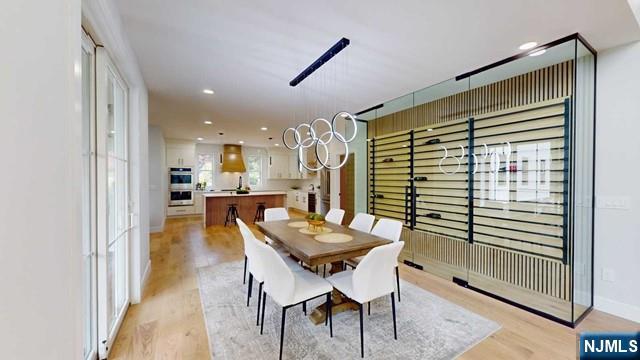 dining area with recessed lighting, baseboards, and light wood finished floors