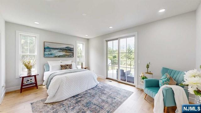 bedroom featuring access to outside, light wood-style flooring, baseboards, and recessed lighting