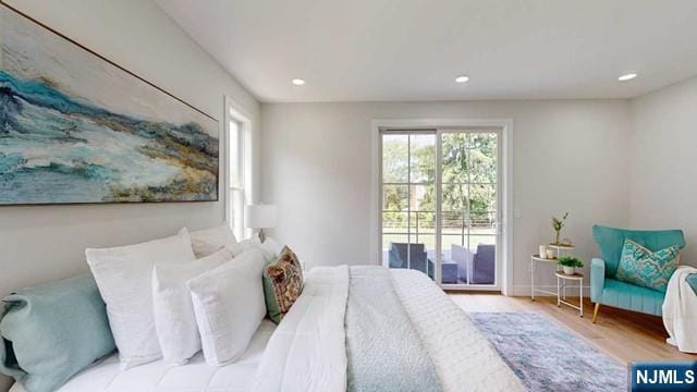 bedroom featuring access to outside, baseboards, recessed lighting, and wood finished floors