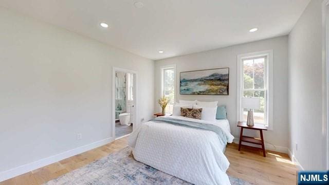 bedroom featuring connected bathroom, baseboards, wood finished floors, and recessed lighting