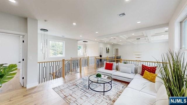 living area with visible vents, coffered ceiling, wood finished floors, beam ceiling, and recessed lighting