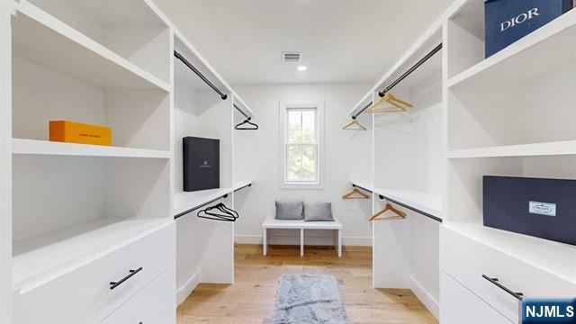 spacious closet featuring light wood-style flooring and visible vents