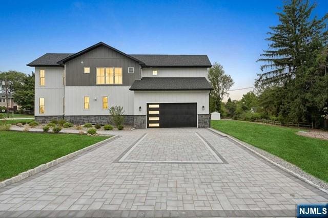 view of front of property with decorative driveway and a front yard